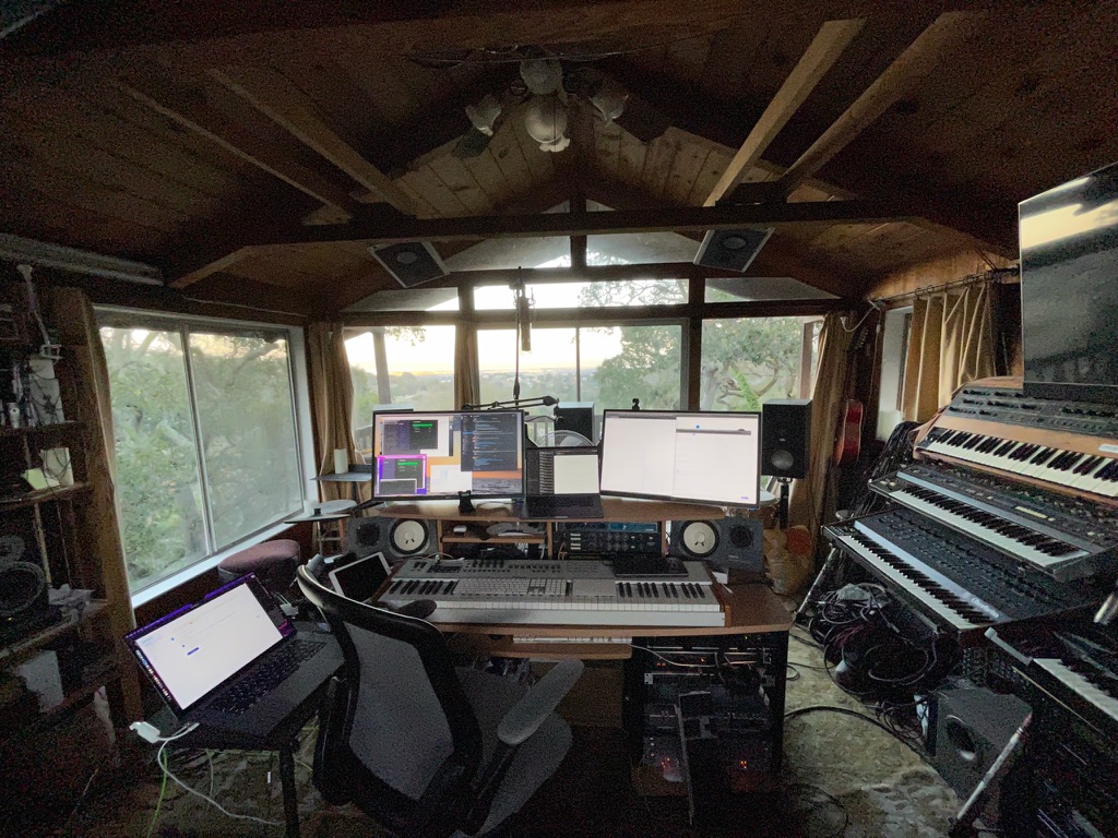 Emerald Hills studio, wood cabin, wrap-around windows, and mix desk.